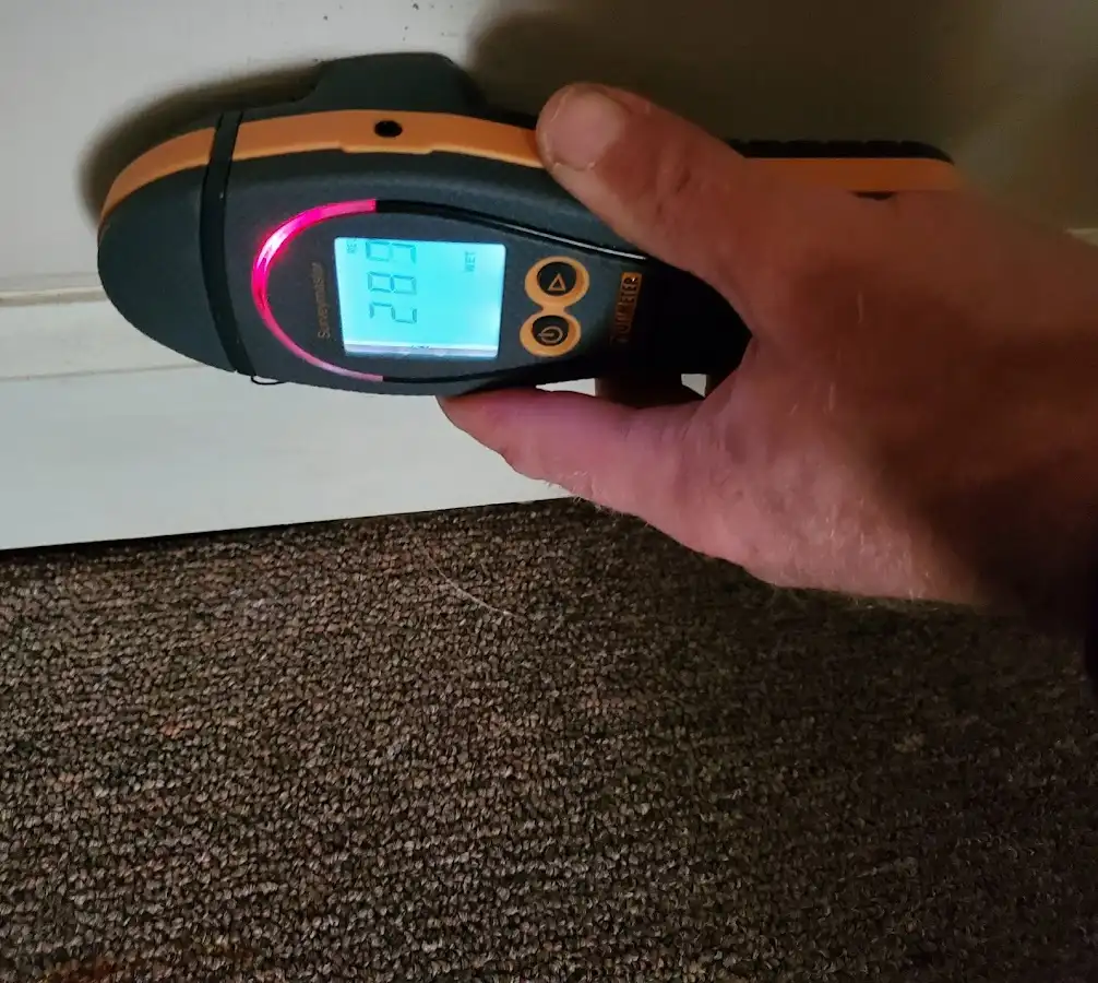 Moisture detection at baseboard during Storm Damage Restoration in Emerson